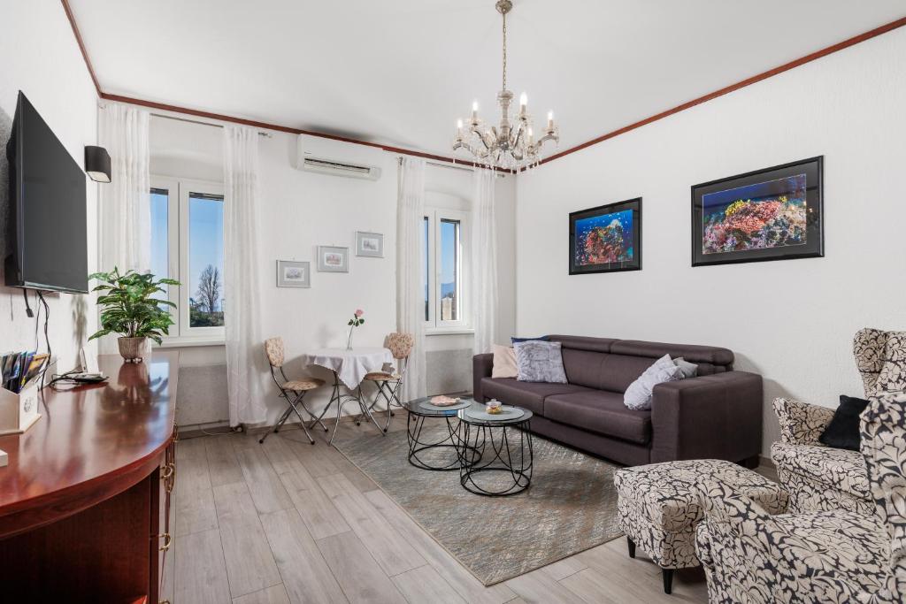 a living room with a couch and a table at Apartment Audrey - free parking by Irundo in Rijeka