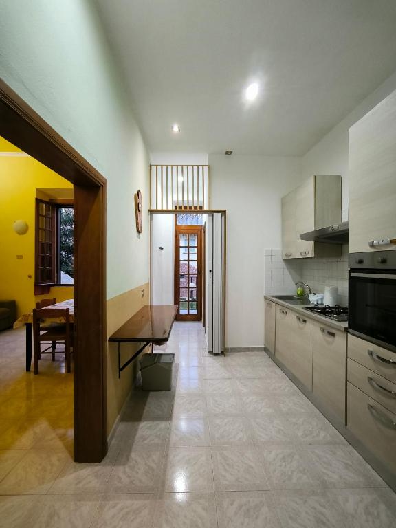 a kitchen with white cabinets and a table in it at Chalet di città in Rome