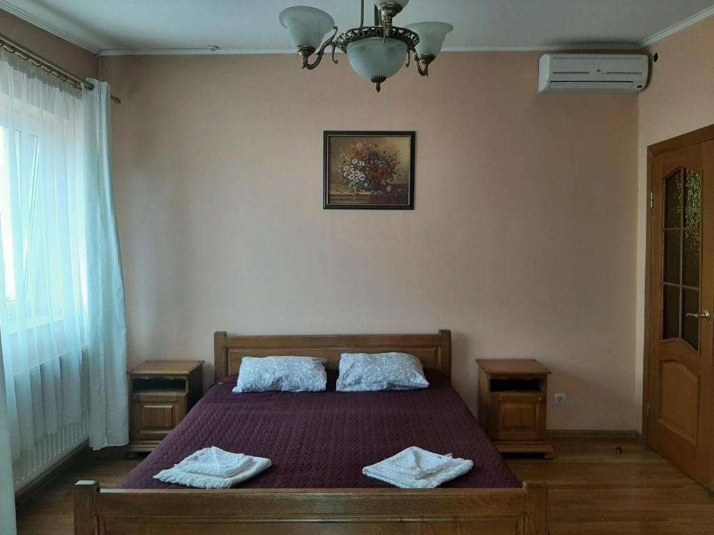 a bedroom with a bed with two pillows on it at Готель Ніколет in Mukacheve
