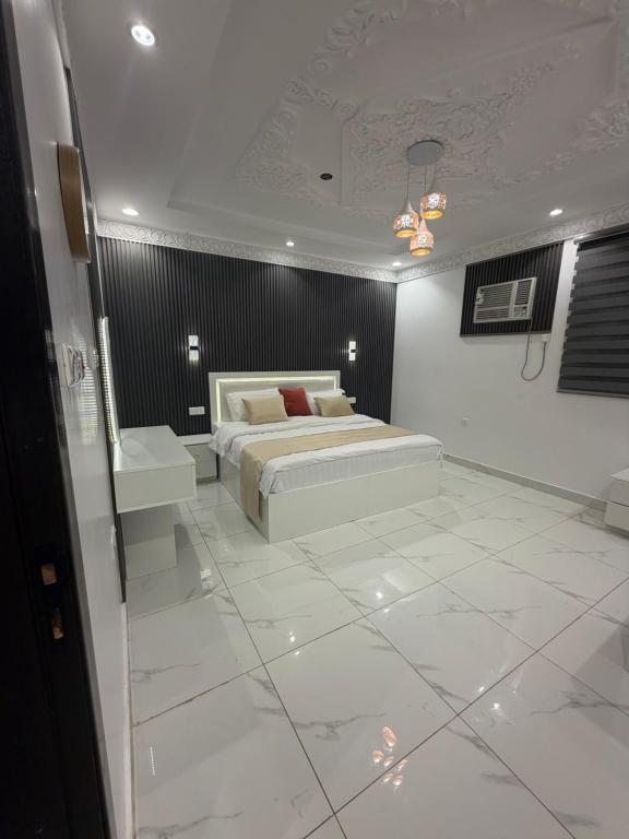 a bedroom with a bed and a white tiled floor at مرافئ in Medina