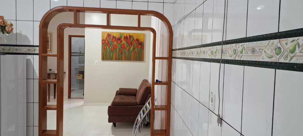 a stairwell with a chair and a painting on the wall at Casa Térrea em Correntina in Correntina
