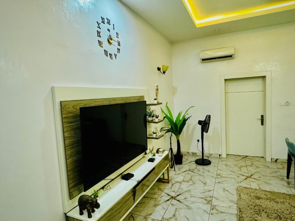 a living room with a large flat screen tv on a wall at Polo Apartments Lekki in Lekki