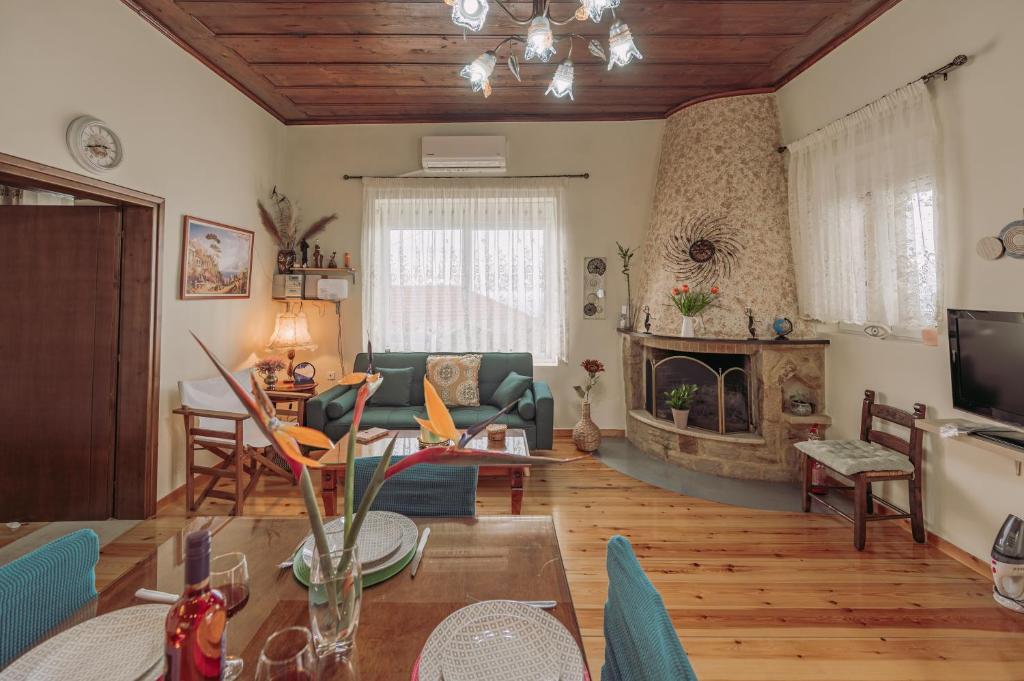 a living room with a couch and a fireplace at The Morus House with Private pool in Melidhónion