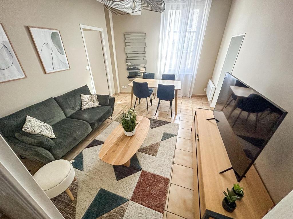 a living room with a couch and a table at La maison des Cordeliers in Loches
