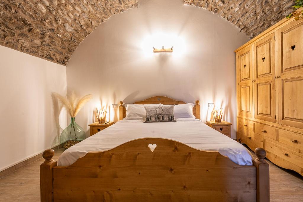 a bedroom with a wooden bed in a room at Antica corte in Zogno