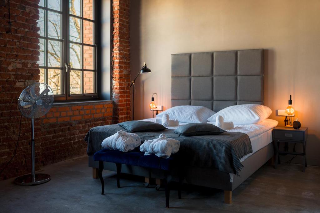 a bedroom with two beds and a fan at ON Rooms Łódź in Łódź