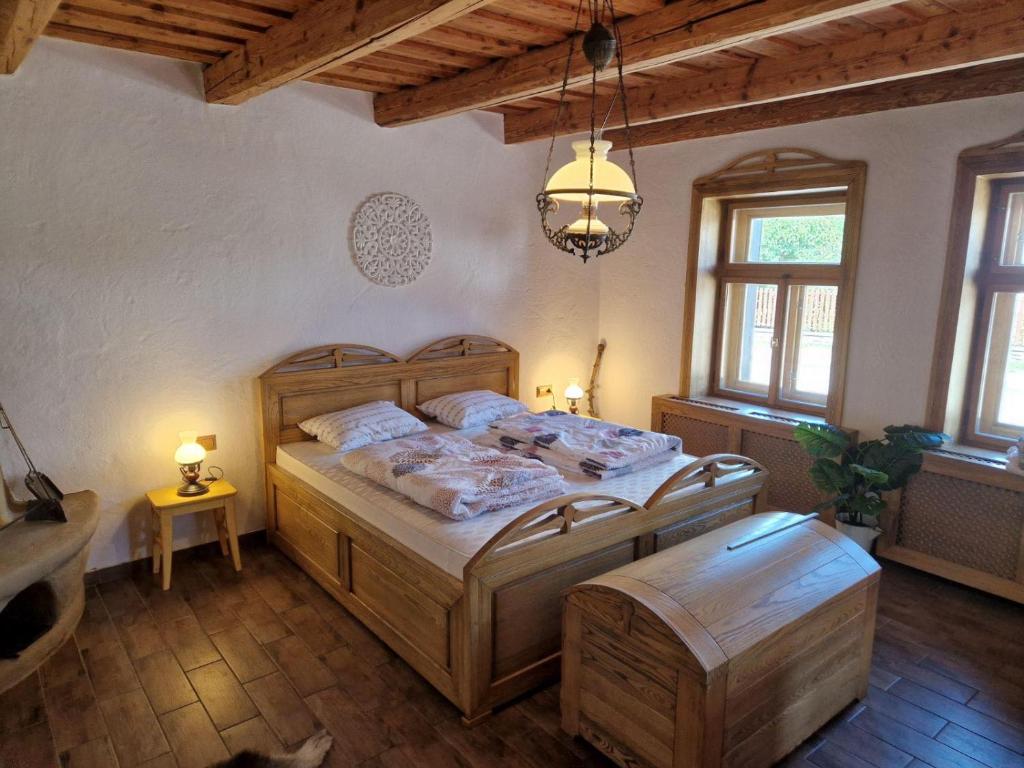 a bedroom with a large wooden bed in a room at 100éves Vendégház in Hárskút
