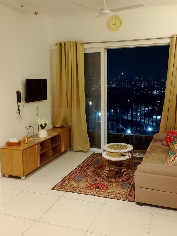 a living room with a view of a city at MaEra's Den in Hinjewadi
