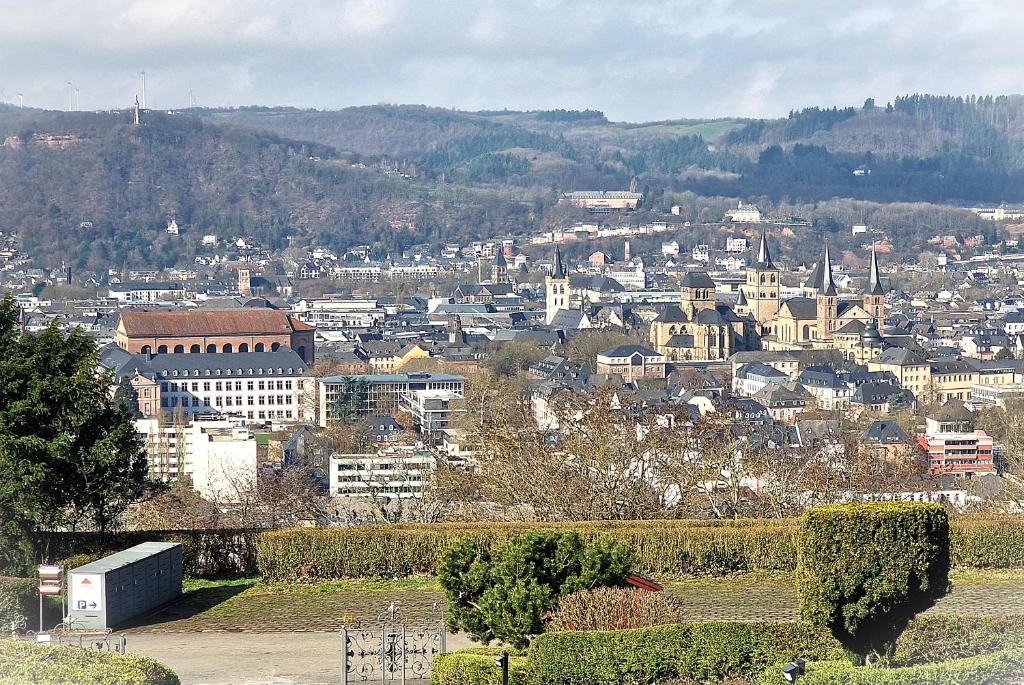 a cityscape of a city with buildings on a hill at Ferienwohnungen Petrisberg in Trier
