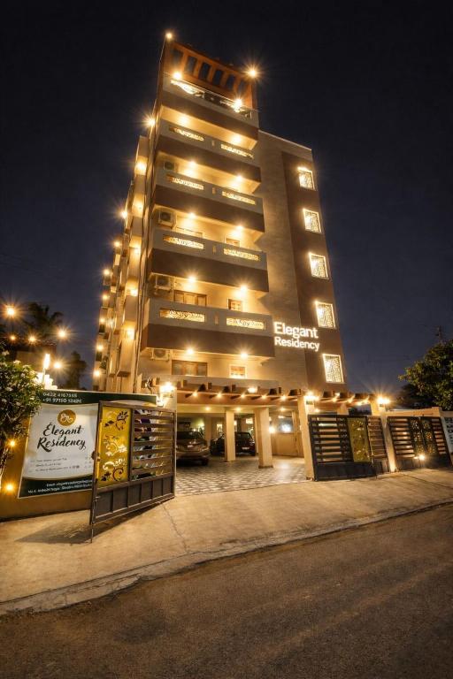 a tall building with lights on top of it at Elegant Residency in Coimbatore