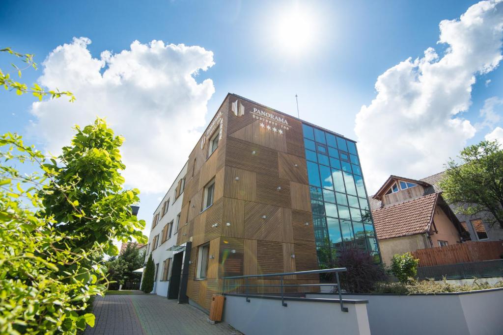 a building with glass windows on the side of it at Pensiunea Panorama Business Inn in Cluj-Napoca