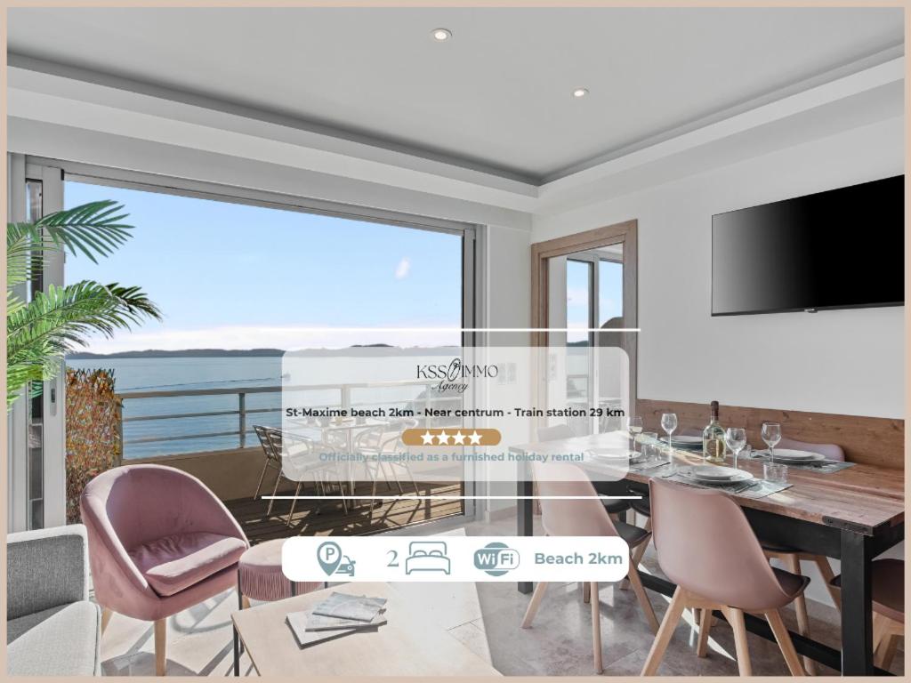 a dining room with a glass table and chairs at Vue Mer - Neuf - Centre Ste Maxime in Sainte-Maxime