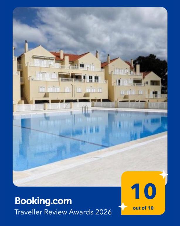 a large swimming pool in front of a building at Varandas de Troia in Troia