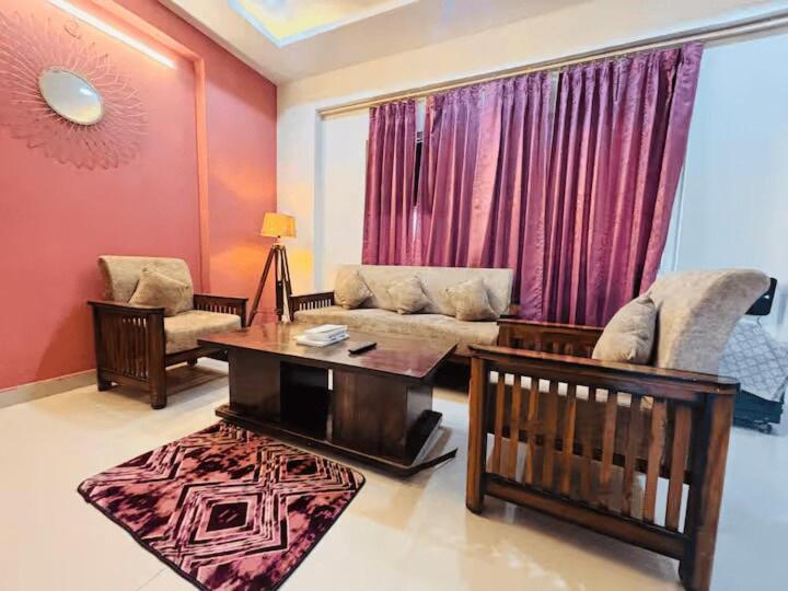 a living room with a couch and a table at The Huddle - Dawn in Dehradun