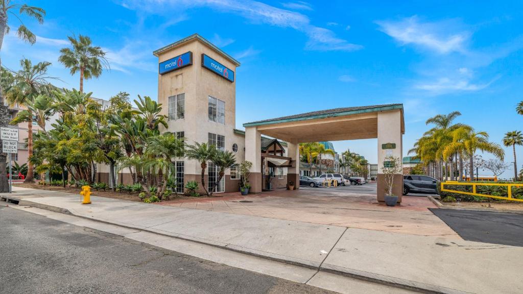 a building on the side of a street with palm trees at Oceanside, CA – Marina / Camp Pendleton in Oceanside