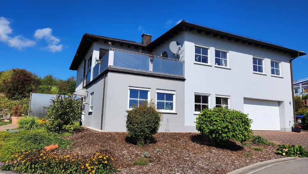 a white house with solar panels on the roof at Benkelberg in Sitzerath