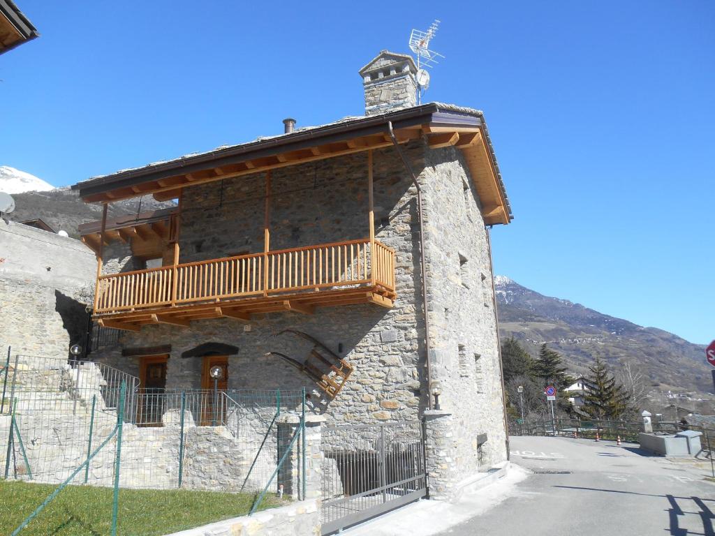 a building with a balcony on the side of it at Le Petit Soleil in Saint-Christophe