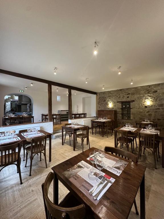 a dining room with wooden tables and chairs at Le Rhum Antik in Puybrun