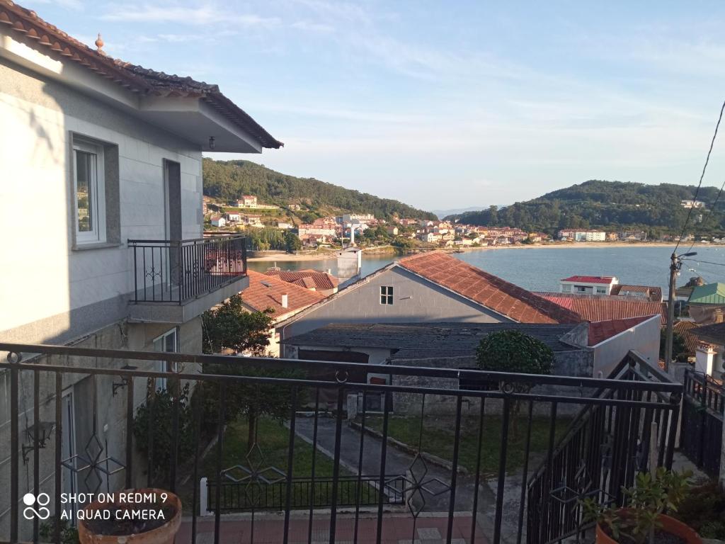 a balcony of a house with a view of the water at A Muradana, Aldán in Pontevedra