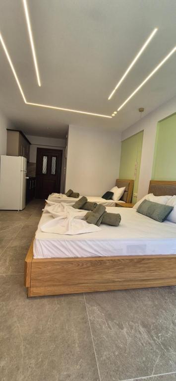 a bedroom with two large beds with white sheets at Petrino 2 by Vasileia in Sarti