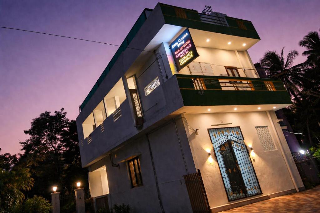 a building with a sign on the side of it at Elite Castle Stay in Kottakupam