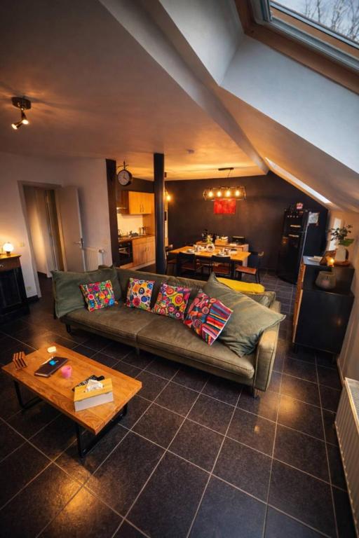 a living room with a couch and a table at Peace&Loft in Durbuy Old in Durbuy