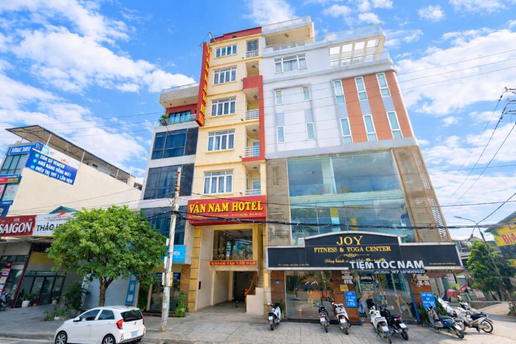 a tall building with motorcycles parked in front of it at Vân Nam Hotel in Cao Bằng