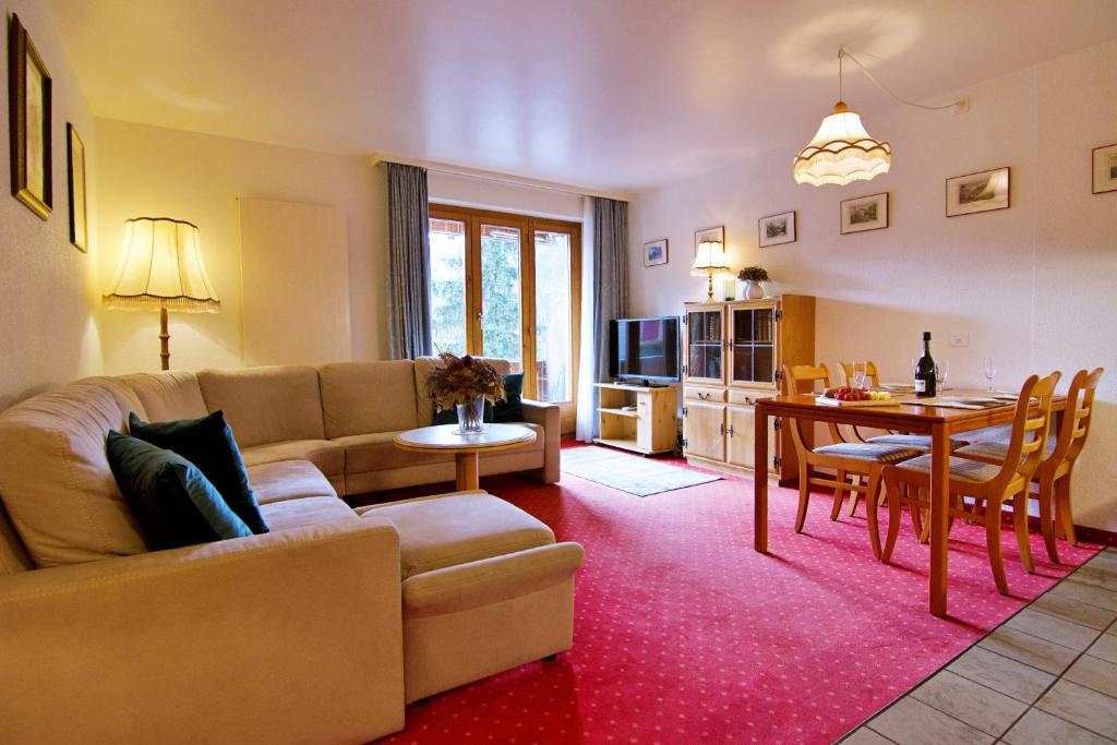 a living room with a couch and a table at Chalet Miravalle 2 in Wengen