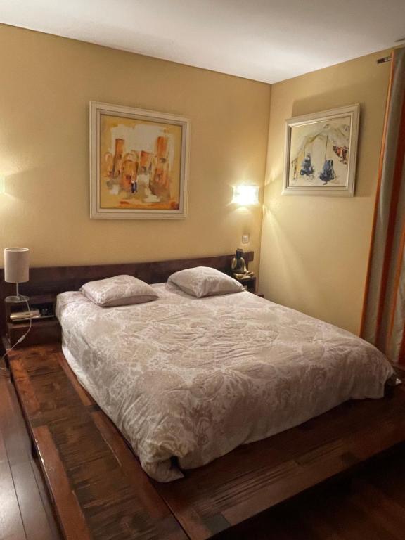a bedroom with a bed with two pillows on it at Villa Portal in La Grande Motte