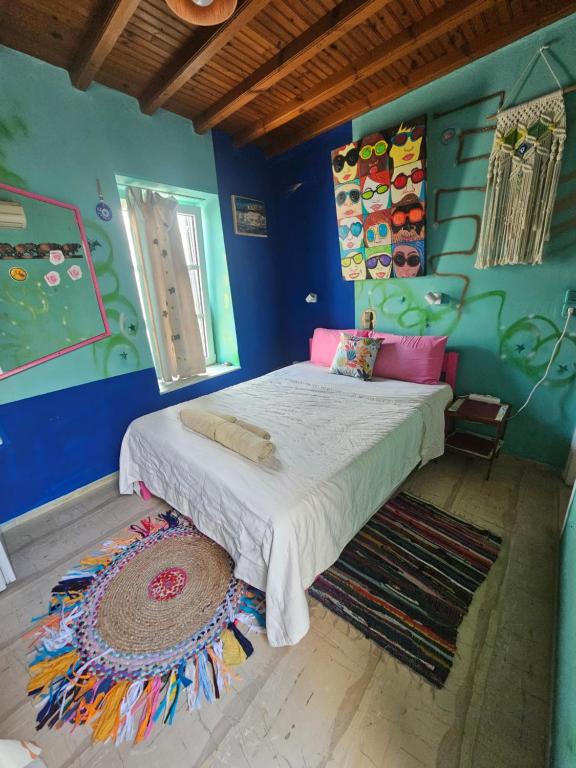 a bedroom with a bed in a blue wall at LaLaLand in Mikonos