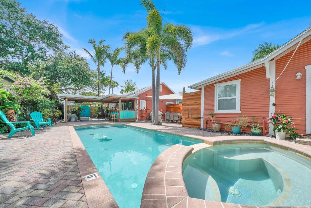 a swimming pool in front of a house at 2 Cottages Downtown Lake Worth - Private Pool in Lake Worth