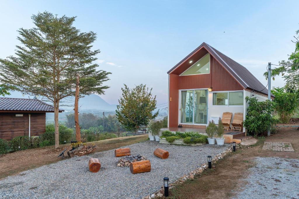 a small house with a gravel yard in front of it at PATTA Hideaway Chiang Dao in Chiang Dao