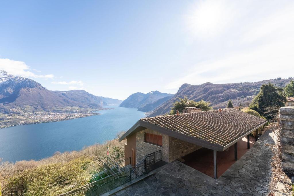 a house on a hill with a view of a river at Villa Bellavista Lakeview Pool in Civenna