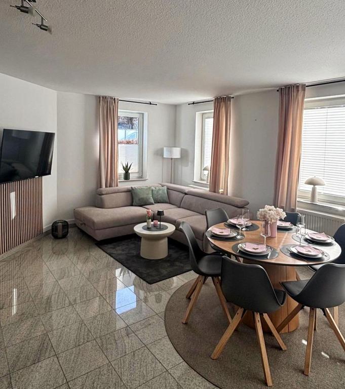 a living room with a couch and a table at Upland-Living in Willingen