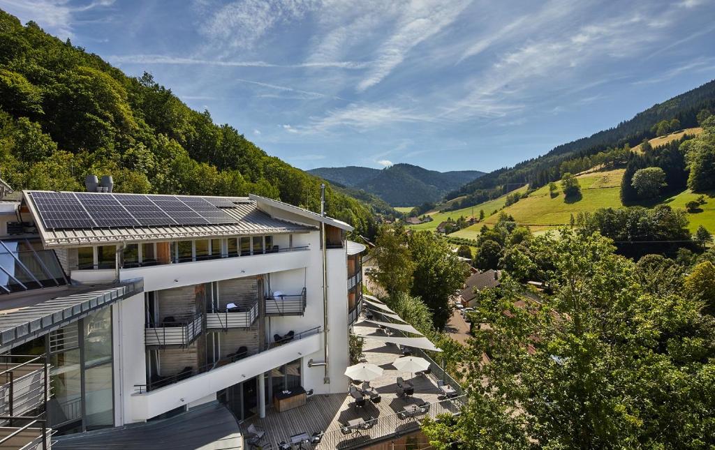 a building with solar panels on top of it at ElzLand Hotel Pfauen WELLNESS & SPA in Elzach
