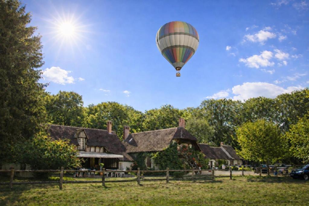 a hot air balloon flying over a house at Auberge Marcheroux in Amboise