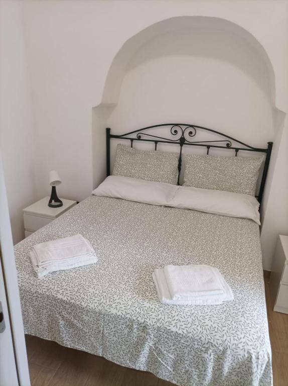 a bedroom with a bed with two white towels on it at Il sottano borgo antico in Bari