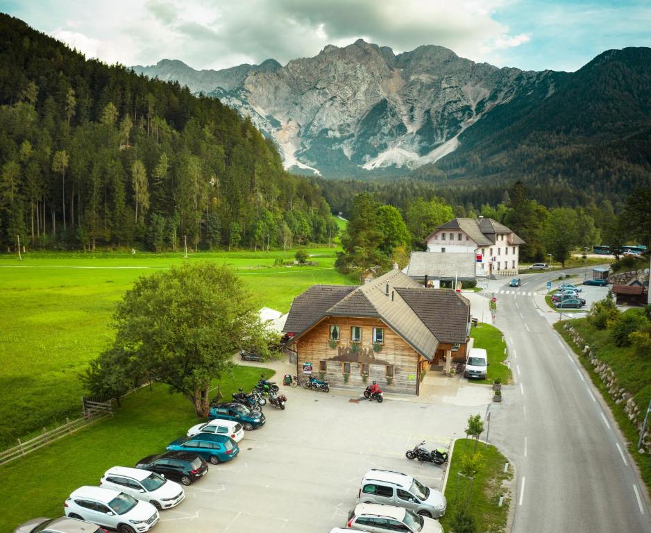 an aerial view of a parking lot in front of a mountain at Rooms Kočna in Zgornje Jezersko