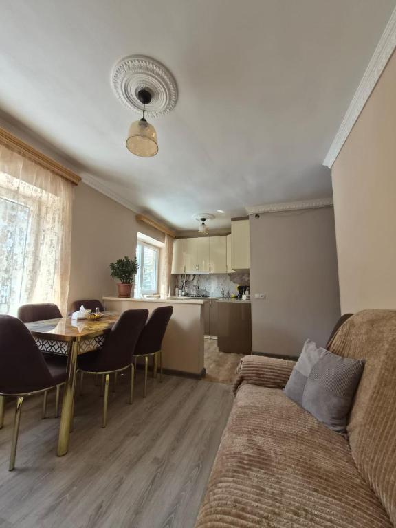 a living room with a couch and a table and a kitchen at Apartment in Jermuk in Jermuk