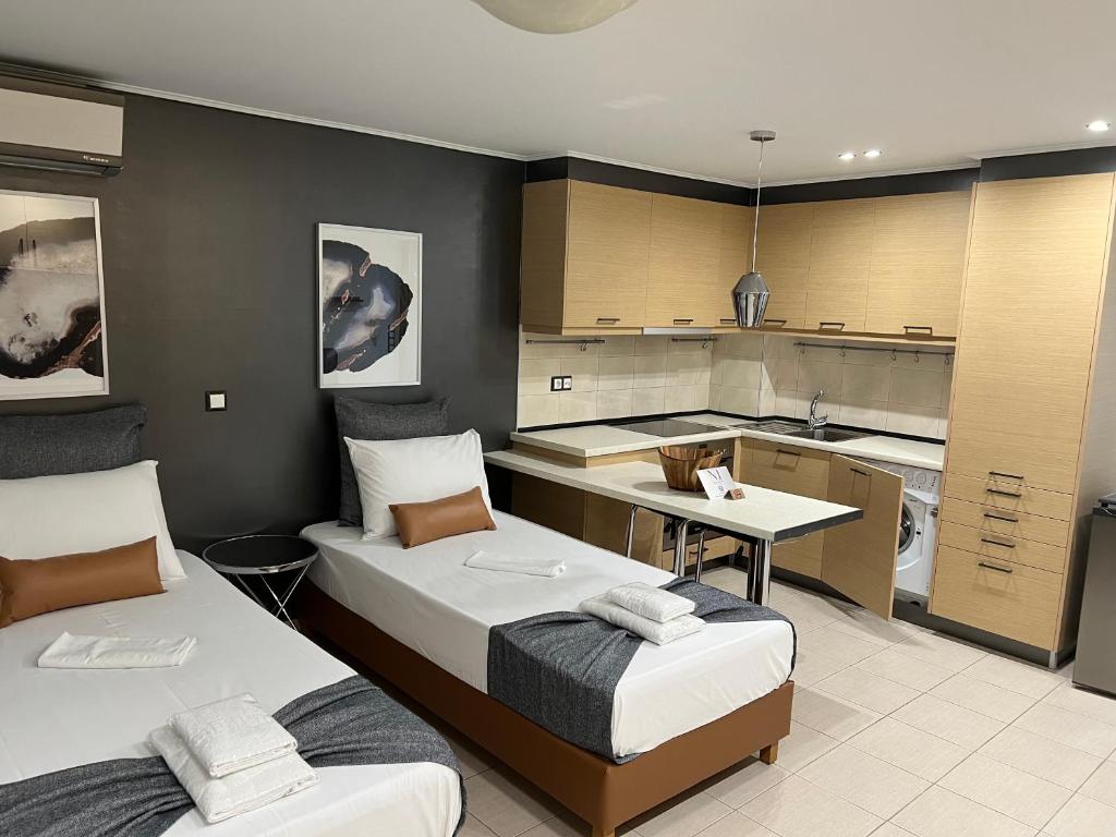 a bedroom with two beds and a kitchen at NJ Lavrio in Lavrio