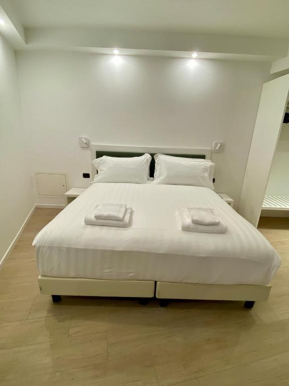 a white bed with two towels on top of it at ANTONELLA's ROOM in Bresso