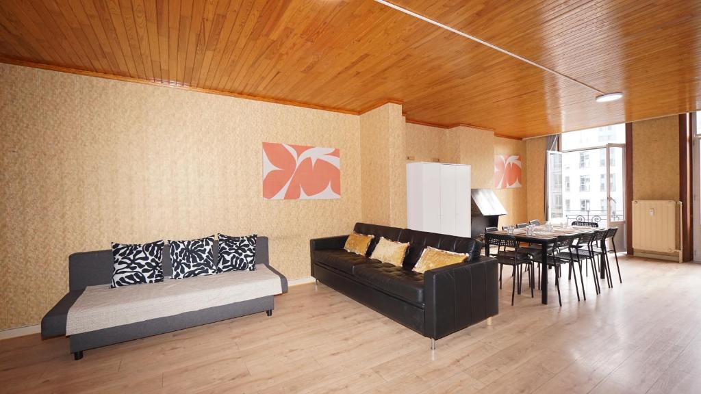 a living room with a couch and a table at Plantin Apartment in Antwerp