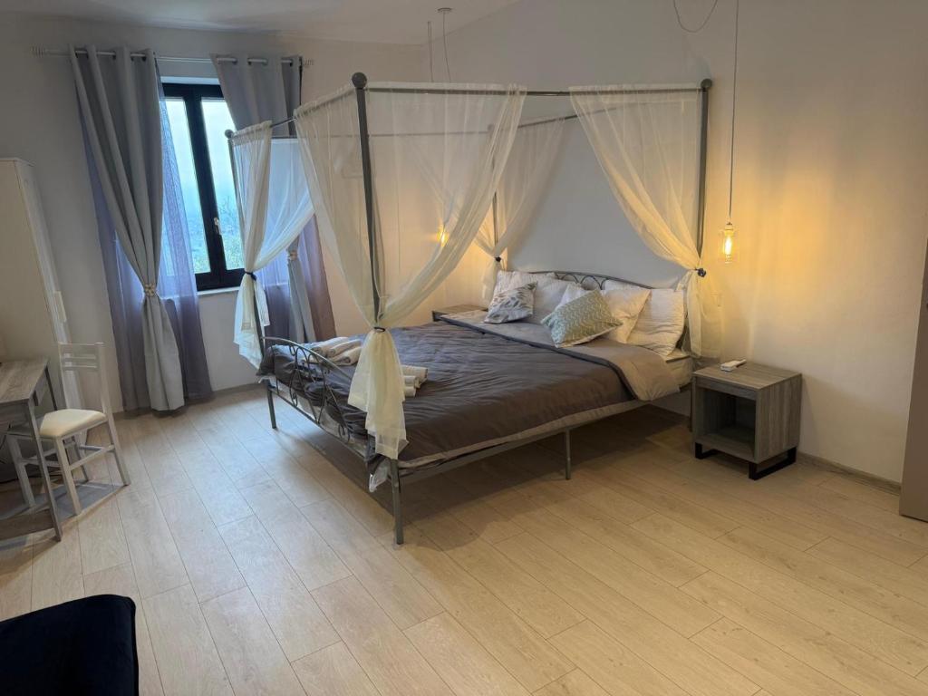 a bedroom with a bed with a canopy at Villa BRUNI Wine Guest House in Montefalco
