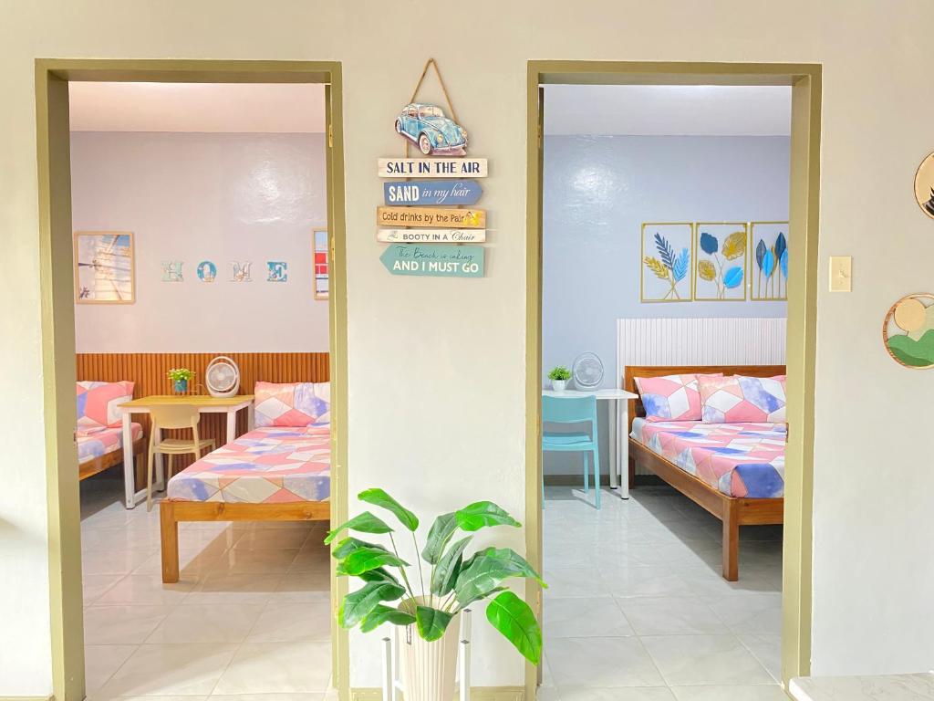 two mirrors in a room with two beds and a table at ZK Homestay in Puerto Princesa City