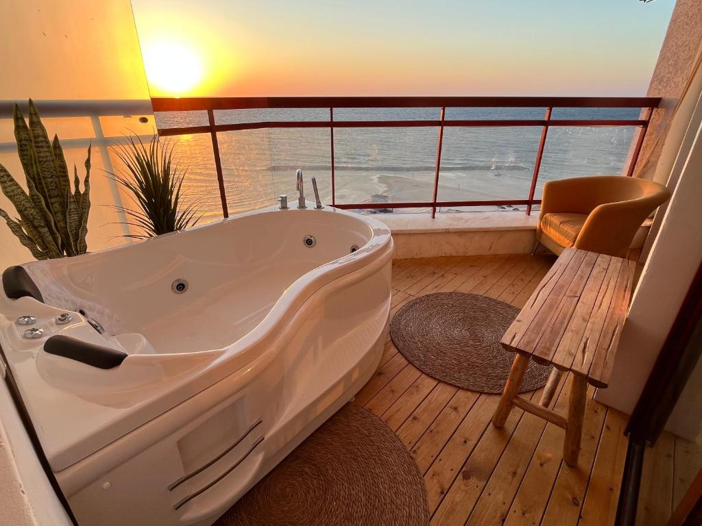 a large bath tub in a bathroom with a window at Lev Yam Suite in Netanya