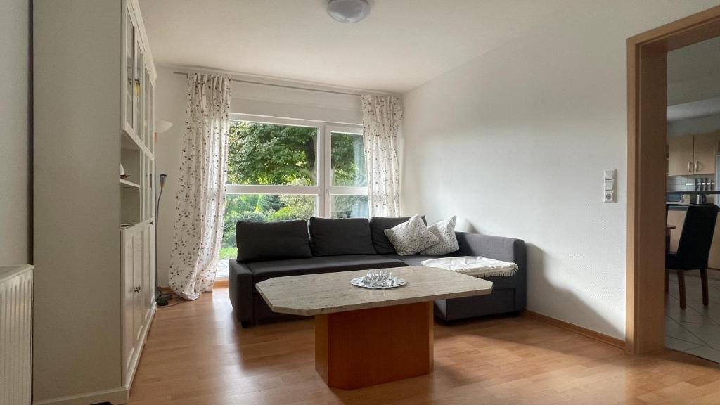a living room with a couch and a table at Ferienwohnung Karl May in Lennestadt
