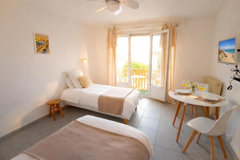 a hotel room with a bed and a table and a window at Le Twins - Appartement de charme à Digoin in Digoin