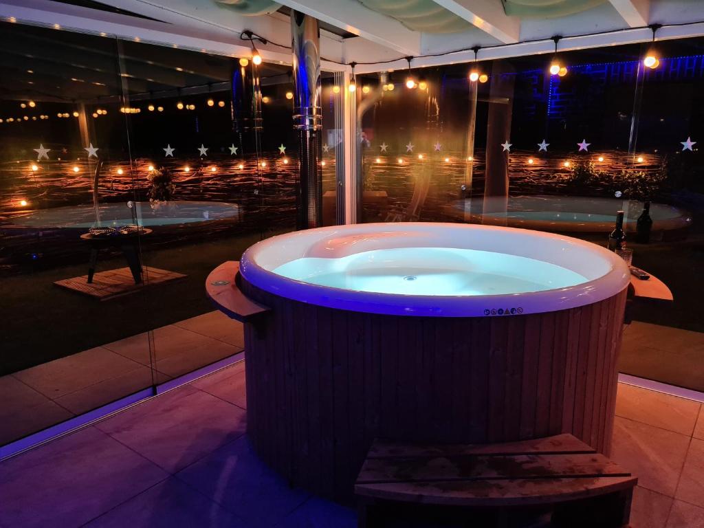 a large bath tub in a building with lights at Ferienhaus Sweet-Escape in Löningen