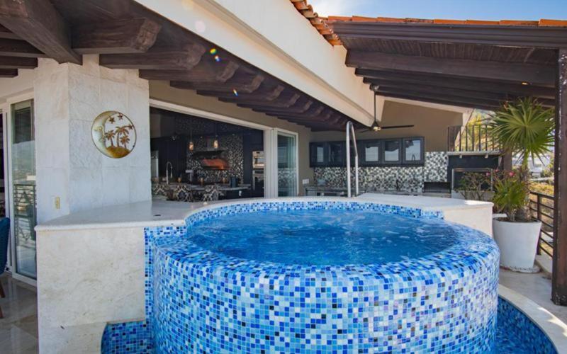 a large pool with blue tiles on a patio at Suites at Zona Romantica in Puerto Vallarta