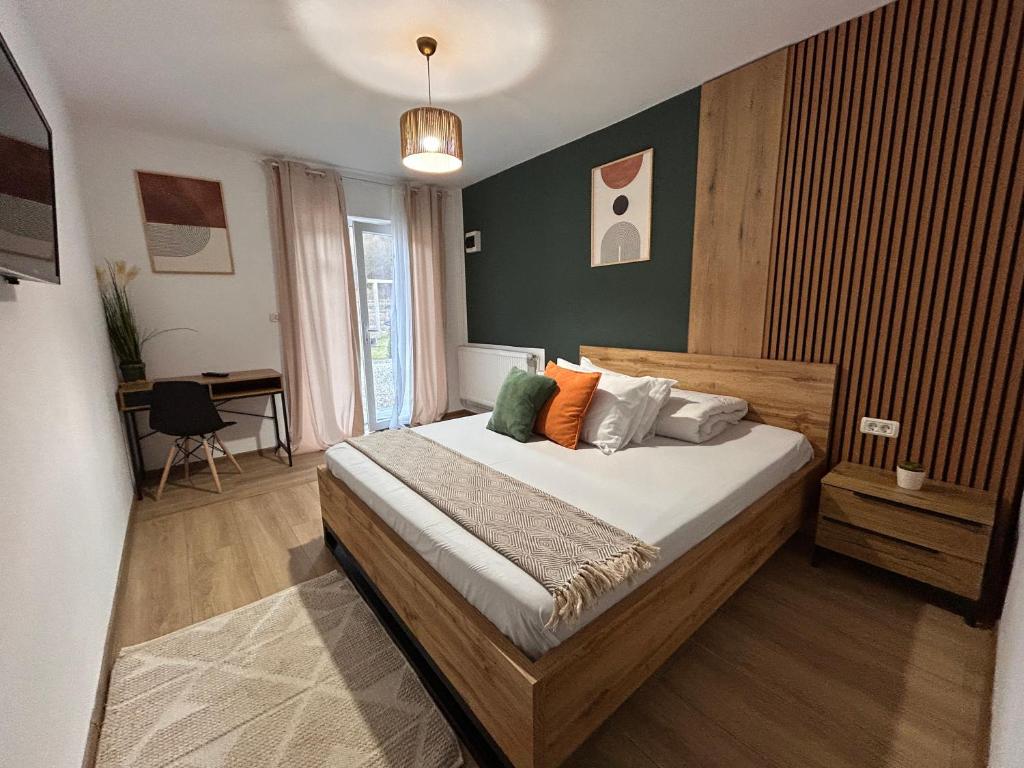 a bedroom with a bed and a desk in it at Casa Irinei in Poiana Mărului